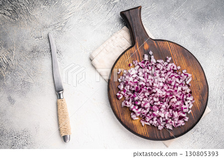 Chopped raw Red onion on wooden board. white background. top view Chopped raw Red onion on wooden board. white background. top view 130805393