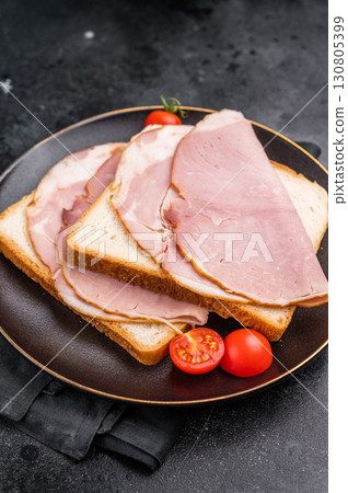 Ham sandwich, toast with sliced Prosciutto Cotto. black background. top view 130805399