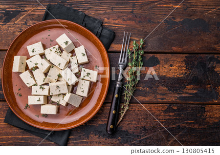 Uncooked Diced soybean tofu cheese on plate. wooden background. top view 130805415