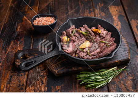 Grilled and sliced Beef top sirloin Steak in a pan. wooden background. top view 130805457
