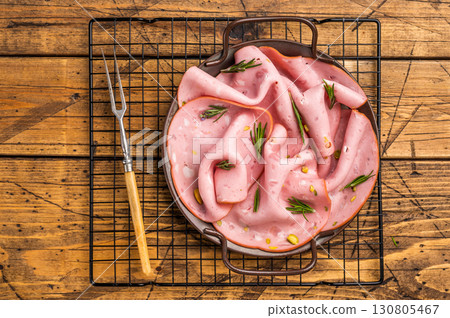 Mortadella sausage slices with pistachios for sandwiches in steel tray. wooden background. top view Mortadella sausage slices with pistachios for sandwiches in steel tray. wooden background. top view 130805467