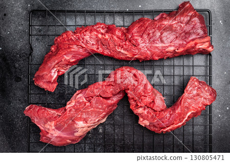 Raw Beef Steak Machete, uncooked meat . black background. top view Raw Beef Steak Machete, uncooked meat . black background. top view 130805471