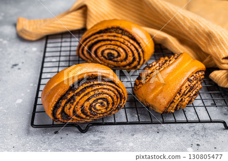 Baked Poppy Seed Rolls. grey background. top view Baked Poppy Seed Rolls. grey background. top view 130805477
