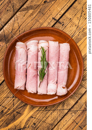 Italian Sliced Prosciutto Cotto ham on plate. wooden background. top view 130805481