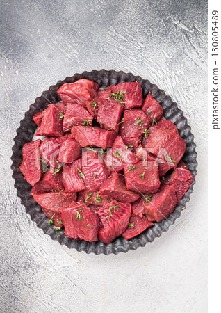 Ready for cooking Diced Raw kangaroo meat. white background. top view Ready for cooking Diced Raw kangaroo meat. white background. top view 130805489
