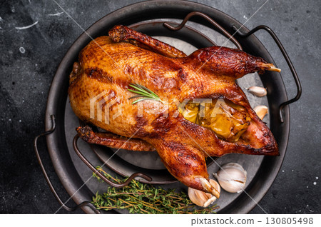 Roasted whole goose on steel tray. black background. top view Roasted whole goose on steel tray. black background. top view 130805498