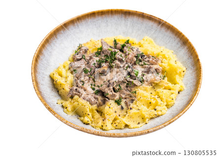Plate of tender beef stroganoff served with creamy mashed potatoes and steaming gravy isolated on white background. top view 130805535