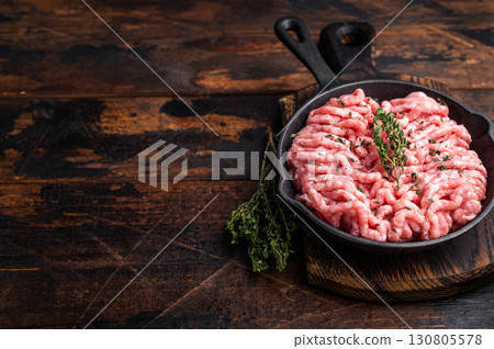 Ready for cooking raw ground pork and beef meat, fresh mince meat in skillet. wooden background. top view Ready for cooking raw ground pork and beef meat, fresh mince meat in skillet. wooden background. top view 130805578