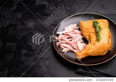 Traditional Smoked chicken leg, poultry meat on plate. black background. top view Traditional Smoked chicken leg, poultry meat on plate. black background. top view 130805589