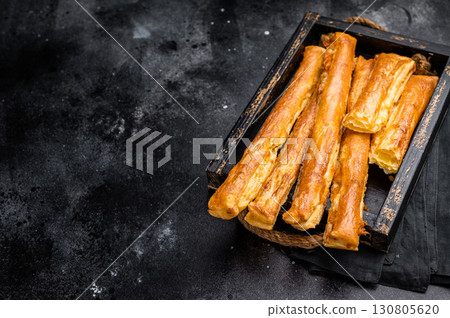 Bread sticks with cheese and salt. black background. top view Bread sticks with cheese and salt. black background. top view 130805620