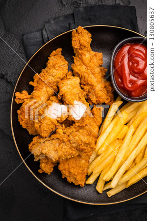 Deep fried chicken strips, sticks with french fry and sauce. black background. top view Deep fried chicken strips, sticks with french fry and sauce. black background. top view 130805637