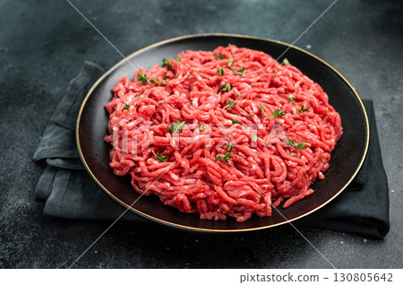 Lamb Mutton ground mince raw meat, forcemeat on a black plate, top view. 130805642