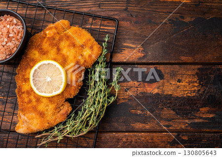 Fried Wiener chicken schnitzel steak, breaded meat. wooden background. top view 130805643