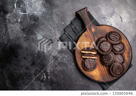 Jaffa Cookies covered with chocolate and filled with jam on wooden board. black background. top view Jaffa Cookies covered with chocolate and filled with jam on wooden board. black background. top view 130805646