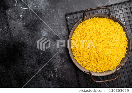 Raw Vermicelli, uncooked pasta in a tray. black background. top view 130805659