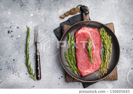 Raw Top sirloin beef steak with herbs. wooden background. top view Raw Top sirloin beef steak with herbs. wooden background. top view 130805685