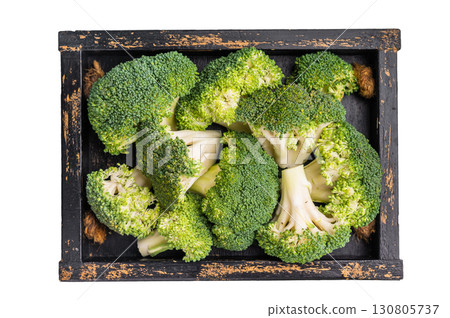 Green raw broccoli pieces in a wooden tray isolated on white background. top view Green raw broccoli pieces in a wooden tray isolated on white background. top view 130805737