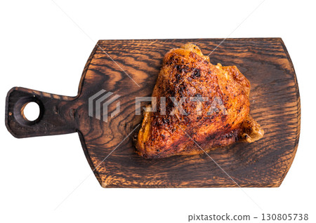 Oven Baked chicken thigh with spices and herb on wooden board isolated on white background. top view Oven Baked chicken thigh with spices and herb on wooden board isolated on white background. top view 130805738