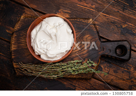 Dip sauce with Fresh Sour cream in a bowl. wooden background. top view Dip sauce with Fresh Sour cream in a bowl. wooden background. top view 130805758