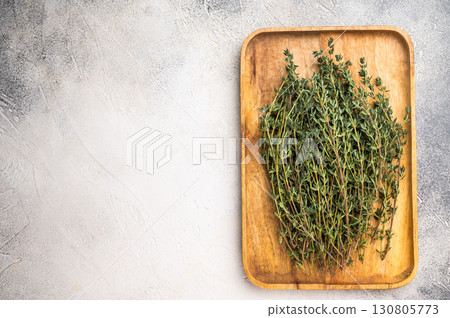 Herb thyme, fresh sprigs in a wooden tray. white background. top view Herb thyme, fresh sprigs in a wooden tray. white background. top view 130805773