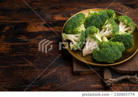 Fresh broccoli cabbage pieces on a plate. wooden background. top view Fresh broccoli cabbage pieces on a plate. wooden background. top view 130805774