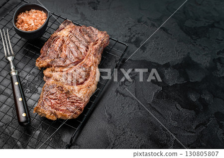 BBQ grilled Chuck eye roll steak, prime beef meat on a steel rack. black background. top view BBQ grilled Chuck eye roll steak, prime beef meat on a steel rack. black background. top view 130805807