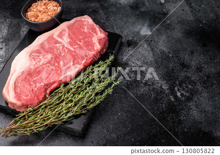 Raw striploin beef steak, New York strip steak. black background. top view Raw striploin beef steak, New York strip steak. black background. top view 130805822