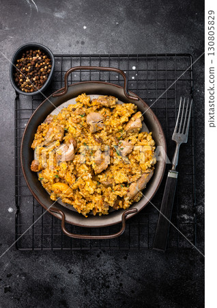 Arabic national rice food pilaf or plov, cooked with fried lamb and beef meat. black background. top view 130805829