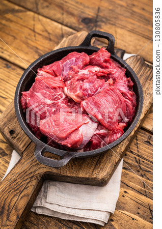 Freshly cut raw beef neck meat, waiting to be seasoned and cooked to perfection for your next culinary creation. wooden background. top view Freshly cut raw beef neck meat, waiting to be seasoned and cooked to perfection for your next culinary creation. wooden background. top view 130805836