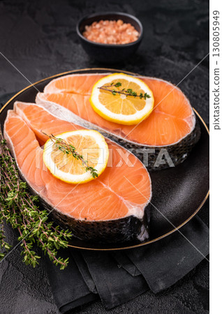 High-quality salmon portion, ready to be transformed into a gourmet dish. A versatile ingredient for both traditional and modern recipes. black background. top view High-quality salmon portion, ready to be transformed into a gourmet dish. A versatile ingredient for both traditional and modern recipes. black background. top view 130805949