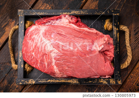 Unccoked Top Round beef, raw topround roast meat with thyme. wooden background. Top view Unccoked Top Round beef, raw topround roast meat with thyme. wooden background. Top view 130805973