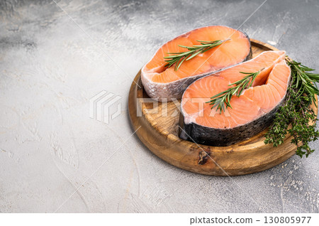Premium salmon loin steak, expertly cut and displayed, perfect for culinary creations. Elevate your dishes with this delicious seafood option. grey background. top view Premium salmon loin steak, expertly cut and displayed, perfect for culinary creations. Elevate your dishes with this delicious seafood option. grey background. top view 130805977