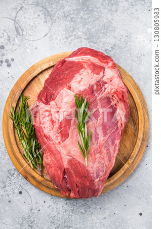 A selection of fresh beef shin, boneless shank meat cuts on a butcher block, emphasizing their quality and versatility for various cooking methods. greybackground. top view A selection of fresh beef shin, boneless shank meat cuts on a butcher block, emphasizing their quality and versatility for various cooking methods. greybackground. top view 130805983