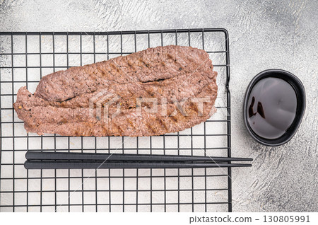 Japanese BBQ yakiniku, grilled wagyu bees strips. grey background. top view Japanese BBQ yakiniku, grilled wagyu bees strips. grey background. top view 130805991