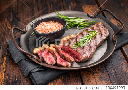 BBQ grilled Top Sirloin beef steak with herbs. wooden background. top view 130805995
