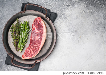 Raw rump cap steak, beef meat, showcasing its rich color and marbling. grey background. top view Raw rump cap steak, beef meat, showcasing its rich color and marbling. grey background. top view 130805996
