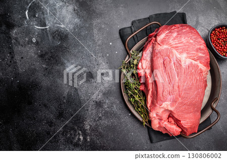 Raw Top Round beef meat cut, topside with hrebs for roast. black background. Top view Raw Top Round beef meat cut, topside with hrebs for roast. black background. Top view 130806002