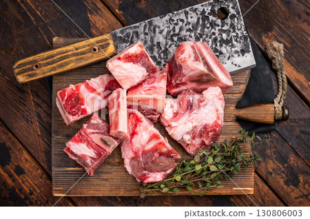 Raw diced Beef meat with bones for stew or goulash on wooden board. wooden background. top view Raw diced Beef meat with bones for stew or goulash on wooden board. wooden background. top view 130806003