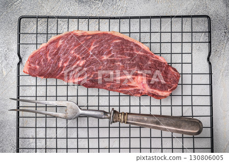 Fresh raw top sirloin steak, showcasing its rich color and marbling. grey background. top view 130806005