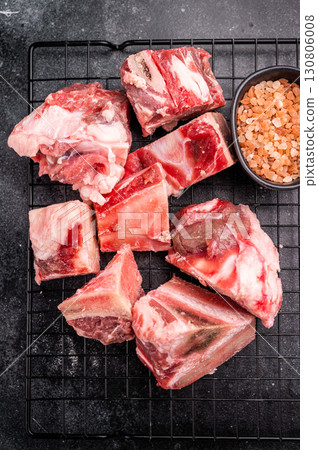 Raw lamb mutton meat and bones for stew or goulash. black background. top view Raw lamb mutton meat and bones for stew or goulash. black background. top view 130806008