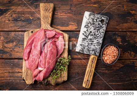 Duck breast fillet, raw sliced poultry meat on butcher board. wooden background. top view Duck breast fillet, raw sliced poultry meat on butcher board. wooden background. top view 130806009