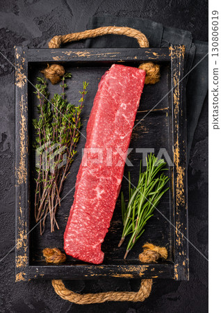 Fresh wagyu brisket cut, beautifully presented with intricate marbling. A must-have for steak enthusiasts looking to elevate their dining options. black background. top view Fresh wagyu brisket cut, beautifully presented with intricate marbling. A must-have for steak enthusiasts looking to elevate their dining options. black background. top view 130806019