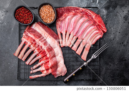 Raw rack of lamb, fresh mutton meat for chops cutlets. black background. top view Raw rack of lamb, fresh mutton meat for chops cutlets. black background. top view 130806051