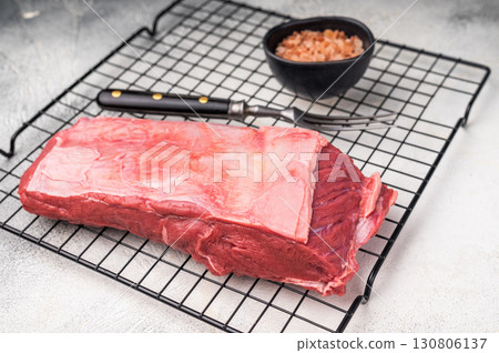 Close-up of raw buffalo meat cuts, highlighting the marbling and vibrant hue, perfect for creating delicious and nutritious dishes. grey background. top view 130806137