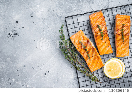 Grilled salmon fillet steak, roast fish on a rack. grey background. top view 130806146