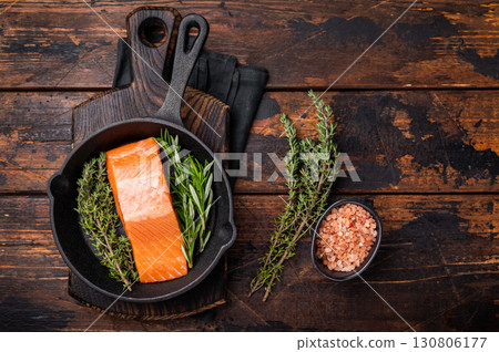 Ready for cooking Fresh Salmon fillets, raw fish steaks in a pan. wooden background. top view Ready for cooking Fresh Salmon fillets, raw fish steaks in a pan. wooden background. top view 130806177