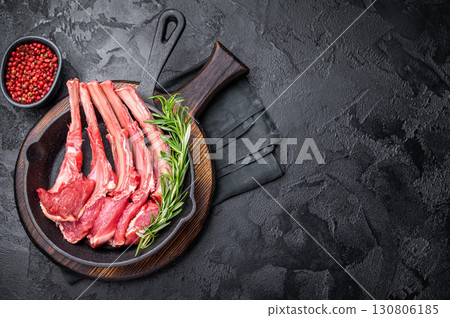 Ready for cooking Raw lamb meat chops, fresh mutton cutlets in a pan. black background. top view Ready for cooking Raw lamb meat chops, fresh mutton cutlets in a pan. black background. top view 130806185