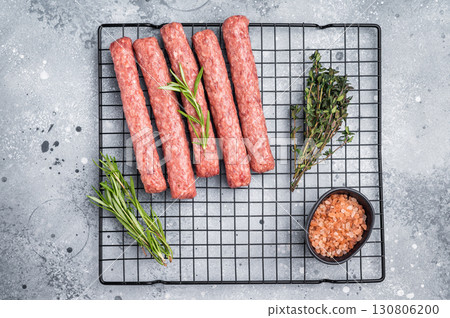 Raw beef and lamb meat kebabs sausages, kofta kebab. grey background. top view 130806200