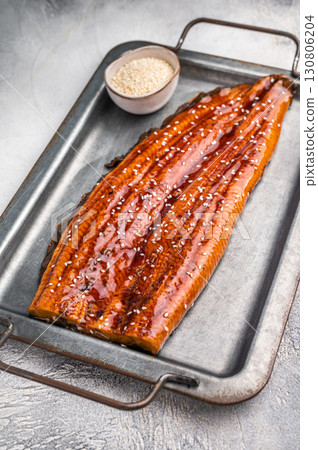 Unagi eel, grilled fish fillet with sauce. grey background. top view Unagi eel, grilled fish fillet with sauce. grey background. top view 130806204