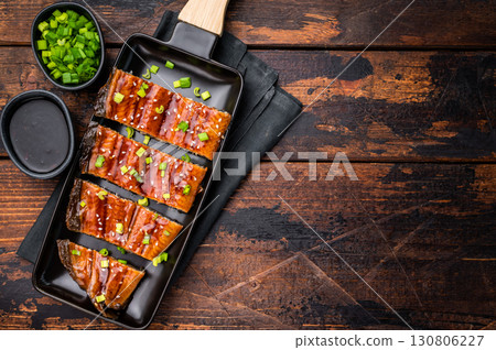 Japanese grilled eel with sweet soy sauce . wooden background. top view Japanese grilled eel with sweet soy sauce . wooden background. top view 130806227